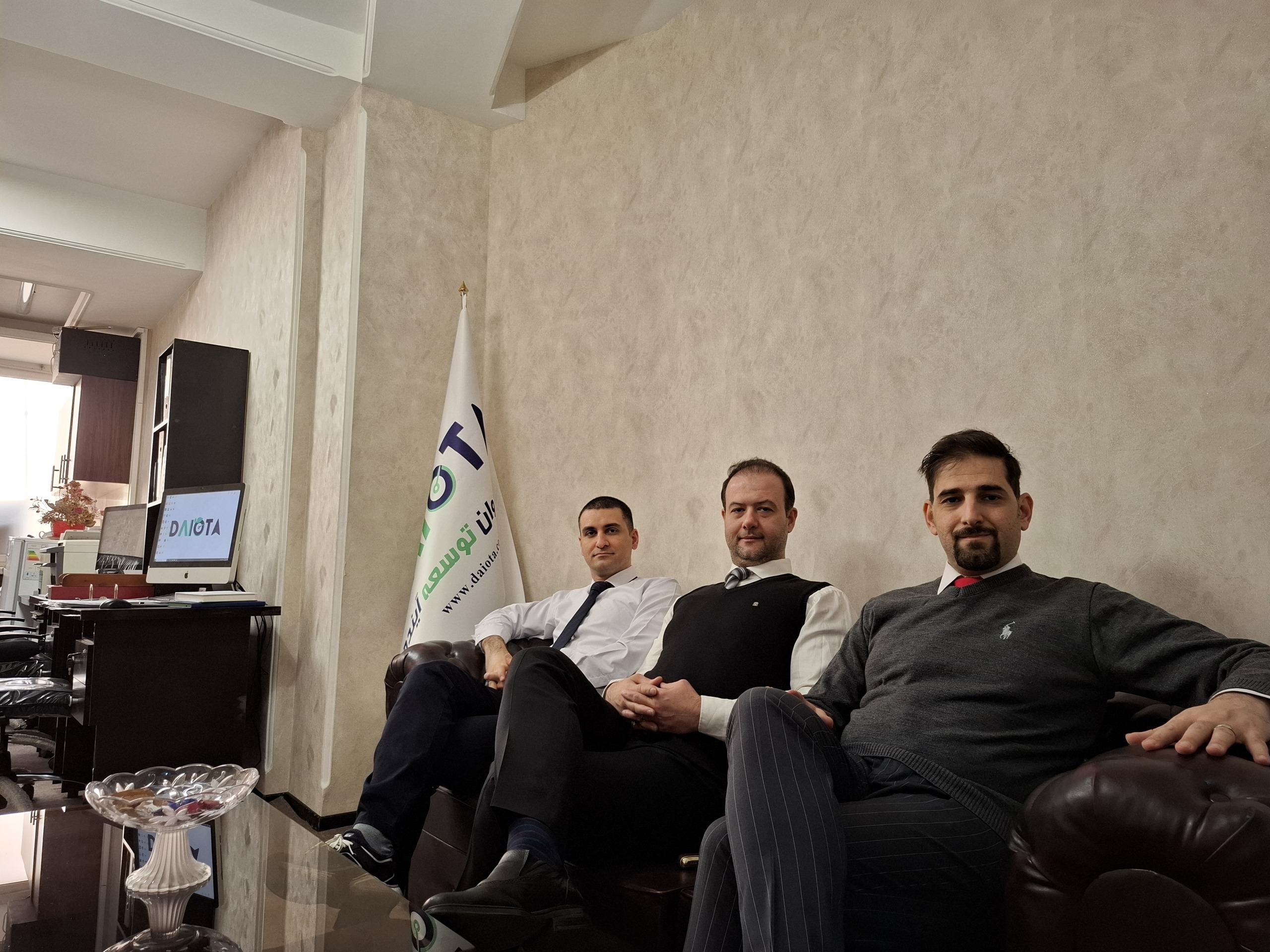 Three DAIOTA team members together in the company office